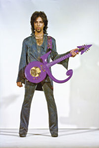 Portrait of Prince with Schecter Purple Symbol Electric Guitar