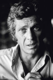 Steve McQueen sitting on his desk